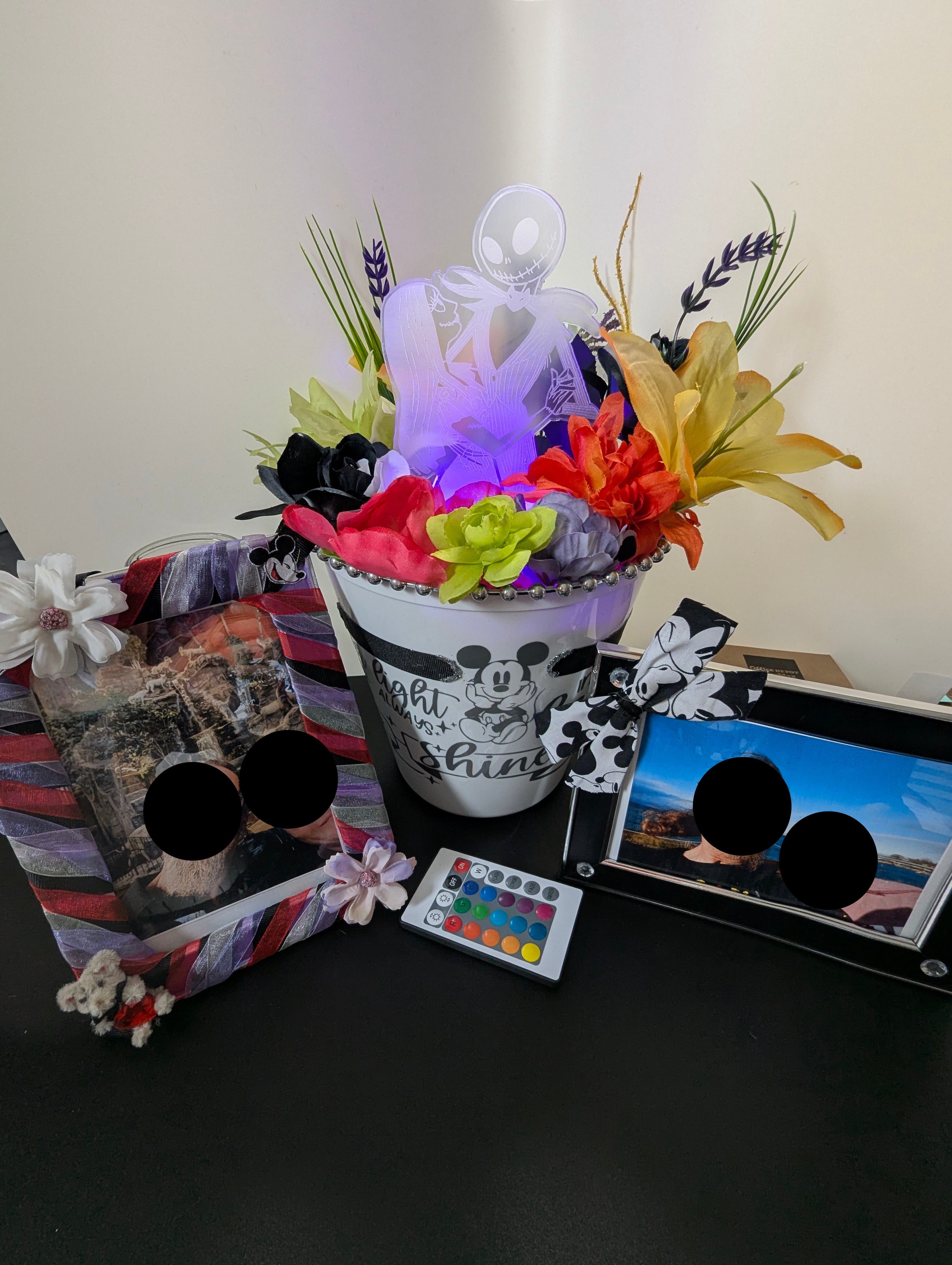 decorative arrangement with lighted character centerpiece. Two customized photo frames featured in this Memorial Bundle.